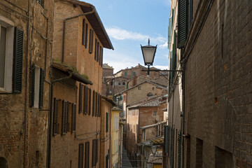 Siena old town narrow streets with medieval buildings, Tuscany, Italy.