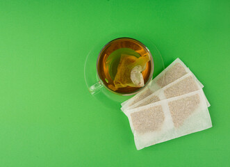 Herbal tea sachet in cup, hot water with chamomile and Hypericum or St. John's wort teabag