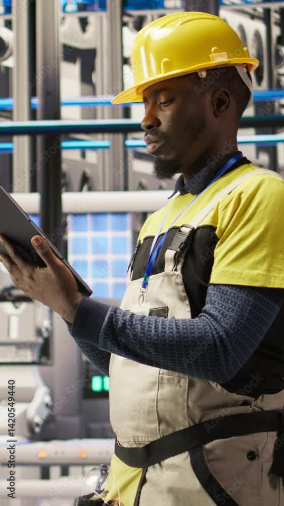 Aufkleber vertical video industrial plant technician using tablet to implement green energy solutions, integra