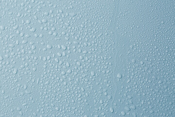Many water drops on light blue background