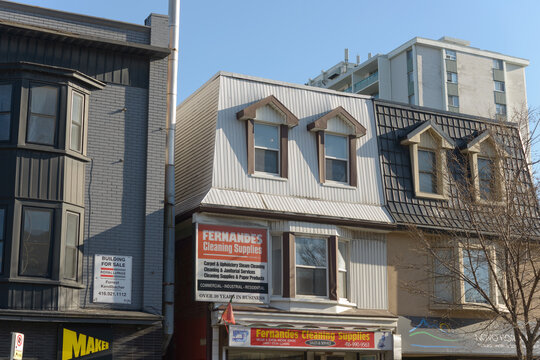 exterior building facade and signs of Maker Pizza and Fernandas Cleaning Supplies 995 and 997 Bloor St W in Toronto, Canada
