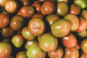 Tomatoes lying in a pile on top of each other, tomato texture.
