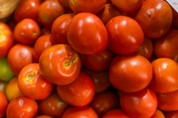 Tomatoes lying in a pile on top of each other, tomato texture.
