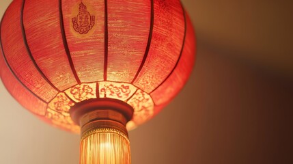 Obraz premium 81.A bright and festive traditional red Chinese paper lantern, glowing with a soft, warm light. The lantern features intricate details, with delicate patterns and a cultural emblem on its surface. It