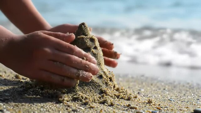 Building a sandcastle by the ocean shore on a sunny day