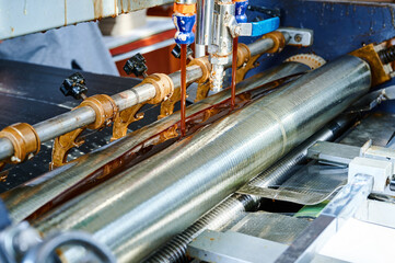 Efficient glue application through an advanced glue-spreading machine at an industrial facility...
