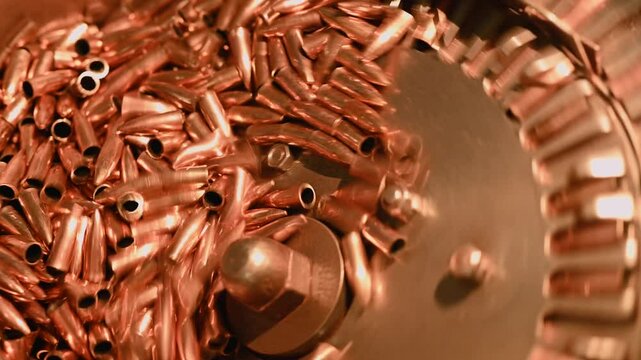 Copper bullet shells in sorting and feeding drum at plant