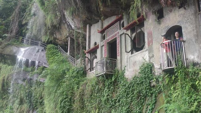 Yinhe Cave Hiking Trail, The waterfall that falls straight down from the cliff on the mountainside is very popular among travelers for its ethereal and beautiful scenery, New Taipei City, Taiwan