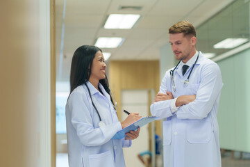 young female doctor consulting patient's medical treatment with professional supervisor at work in the hospital