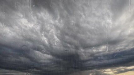 fast timelapse clip with massive rain and big cold leaden clouds