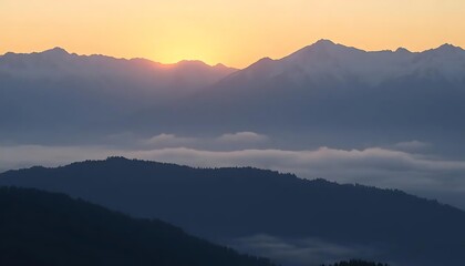 Mystical dawn over the cloud-veiled alpine landscape with sun rays peaking through