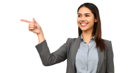 An attractive businesswoman in a gray suit is pointing to her right, smiling and looking there.