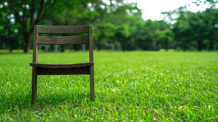 Wooden Chair on Green Grass in Tranquil Park Setting for Relaxation and Nature Appreciation