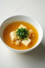 Golden broth, soft tofu, vibrant seaweed in a classic white bowl , japanese cuisine, soup, tasty