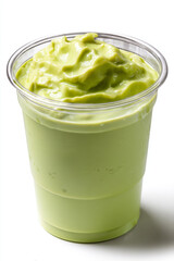 Creamy avocado smoothie in clear plastic cup, smooth texture
