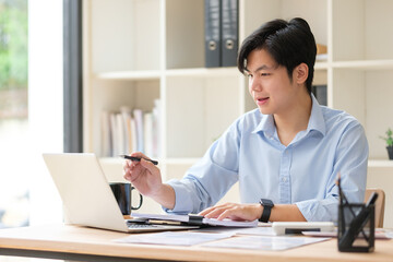 Businessman using laptop and planning business strategy at office desk.