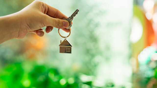 House model and key in home insurance broker agent ‘s hand or in salesman person. Real estate agent offer house, property insurance and security, affordable housing concepts