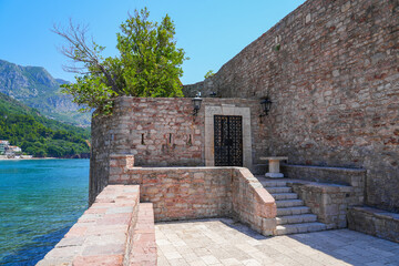 Gateway of Sveti Stefan, a medieval village located on a small island connected to the mainland by...