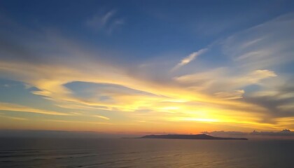 Vibrant sunset paints the sky with golden hues above a serene seascape