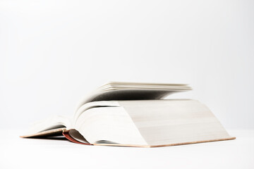 Open book with debunked pages lies on white background. Fantasies and those imagination.