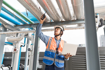 Engineer, Plumber, Building utilities on rooftop. Male engineer checks, repair or maintenance of...