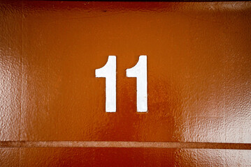 The number 11 written on a door