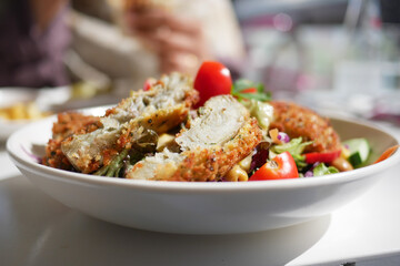 Crispy fried food served with fresh vegetables at a dining table