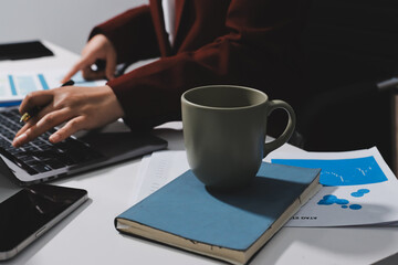 Tax deduction planning concept. Women use a calculator to calculate expenses and taxes to receive...