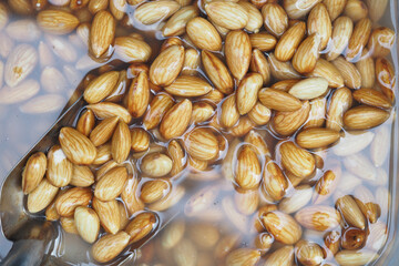 Soaking almonds in water for preparation in a kitchen setting