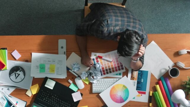 Top down view of designer work on palettes and crumpled paper. Top view of skilled business man run out of idea while sleeping at meeting table. Project manager crumpled and throw paper. Symposium.