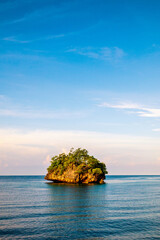 Natural view of small islands from the middle of the ocean at sunset