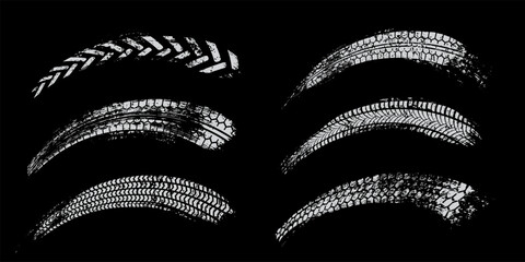 Tire track set. White tyre marks of car, bike, motorcycle with grunge effect on black background. Wheel footprint, road element, dirty rubber protector pattern. Realistic vector illustration. © backup16