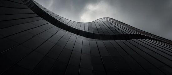 Modern architectural marvel, dark fa?ade with geometric lines and cloudscape