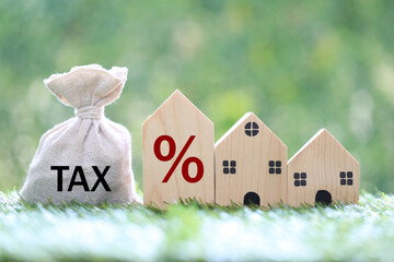 Estate tax, Model house and percentage symbol icon and stack of coins money on natural green background,Business investment and Property tax concept