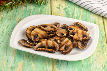 Tasty hot grilled champignon mushrooms