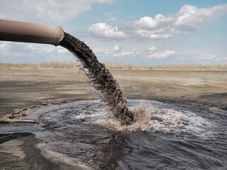 Dirty sewage pollutes the environment. Powerful waste stream from the pipe.