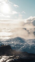 A serene seascape with waves and mist under a bright sky.