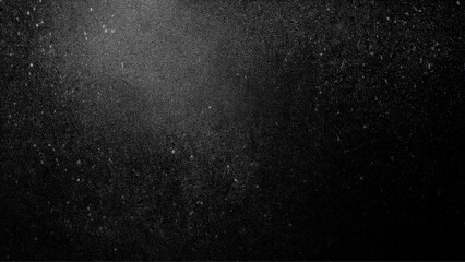 Black matte textured background with floating dust particles illuminated by soft light Vintage black and white noise texture. Soft gray texture with subtle variations, Abstract vector texture 