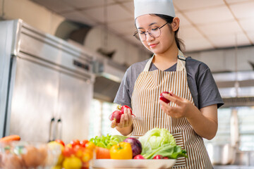 Young Female Chef Preparing Fresh Vegetables in Professional Kitchen