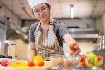 Smiling Female Chef Preparing Ingredients in Professional Kitchen