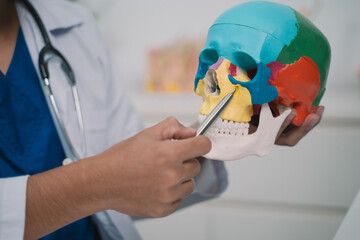 In the hospital, the doctor reviewed the x-ray of the patient's skull, prioritizing health care and...