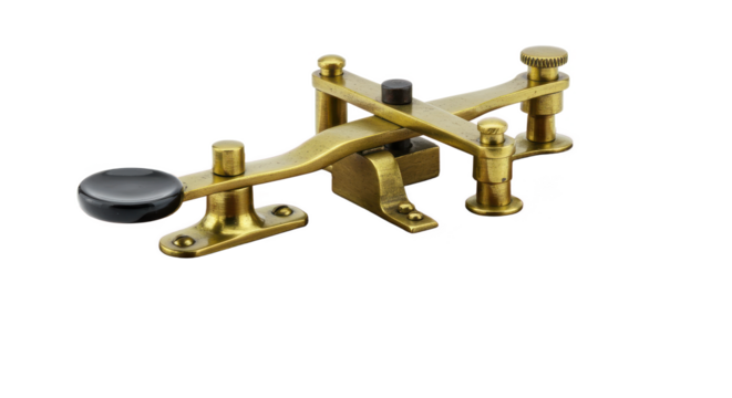 A close up of a vintage brass morse code key with a black knob on a black background studio shot