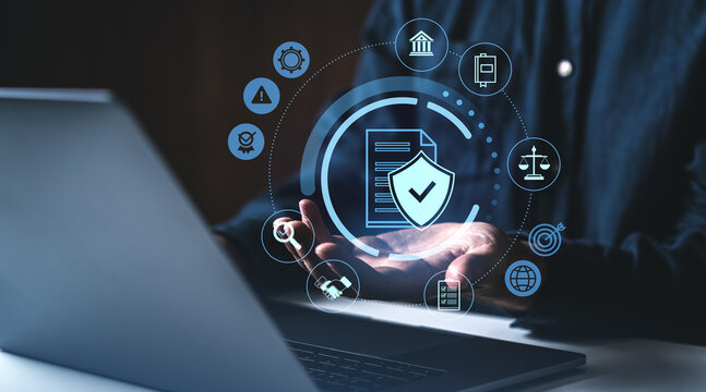Cybersecurity compliance concept with digital shield and document icons on screen.