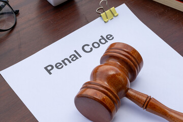 Criminal Law Reference: Penal Code in Folder and Gavel on Tabletop