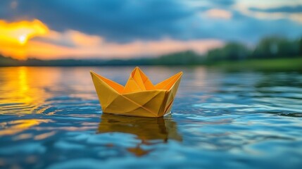 A paper boat floating on top of a body of water