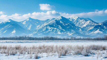 Obraz premium Majestic snow capped mountains rise above a serene winter landscape, showcasing stunning natural beauty.