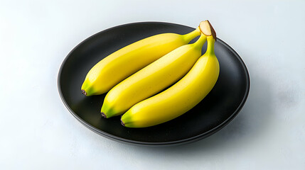 Three Ripe Yellow Bananas on a Black Plate