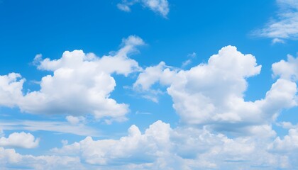 Clear blue sky filled with soft, fluffy white clouds floating gently, creating a bright and peaceful atmosphere on a sunny day with natural daylight