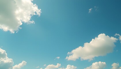 Clear blue sky filled with soft, fluffy white clouds floating gently, creating a bright and peaceful atmosphere on a sunny day with natural daylight