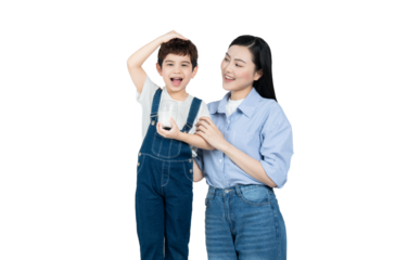 portrait of asian boy drinking milk and posing with mother on background